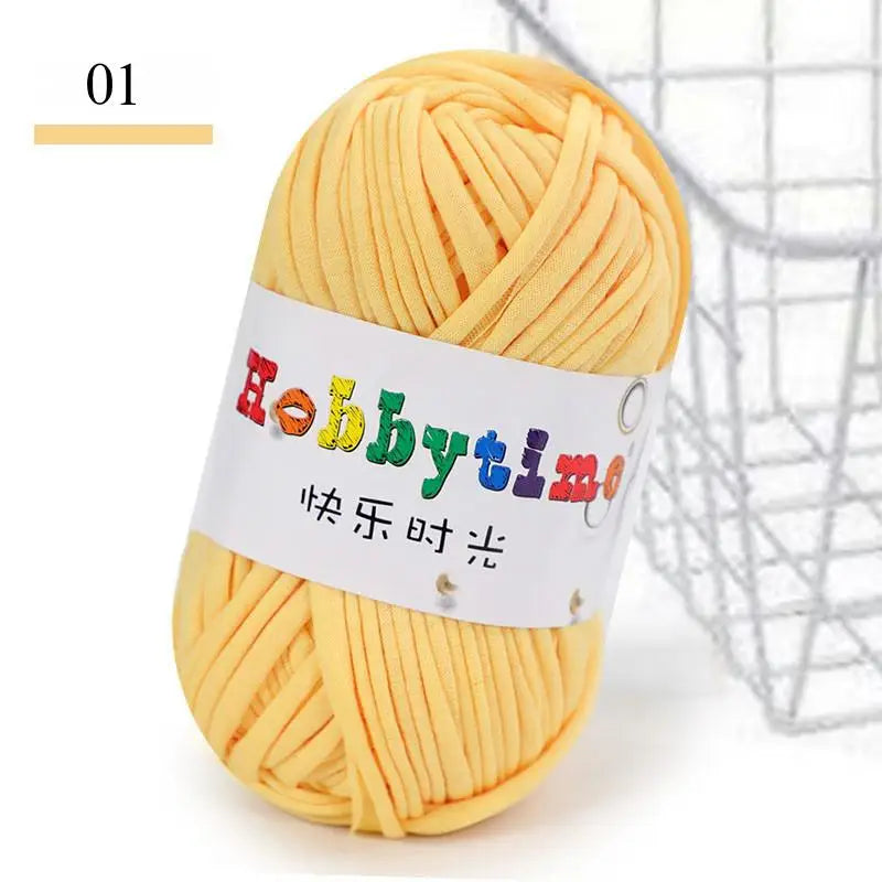 A ball of thick yellow craft yarn is shown next to a wire mesh basket.