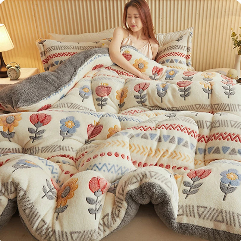 A cozy winter blanket featuring a floral pattern in cream and gray tones, draped over a bed.