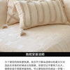 Cream knit pillow covers displayed on a sofa, showing the texture and stitching detail.