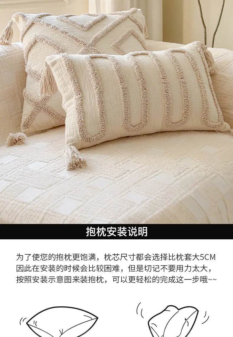 Cream knit pillow covers displayed on a sofa, showing the texture and stitching detail.