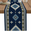 A dark blue linen table runner featuring an Indian-inspired geometric pattern in cream, yellow, and light blue.