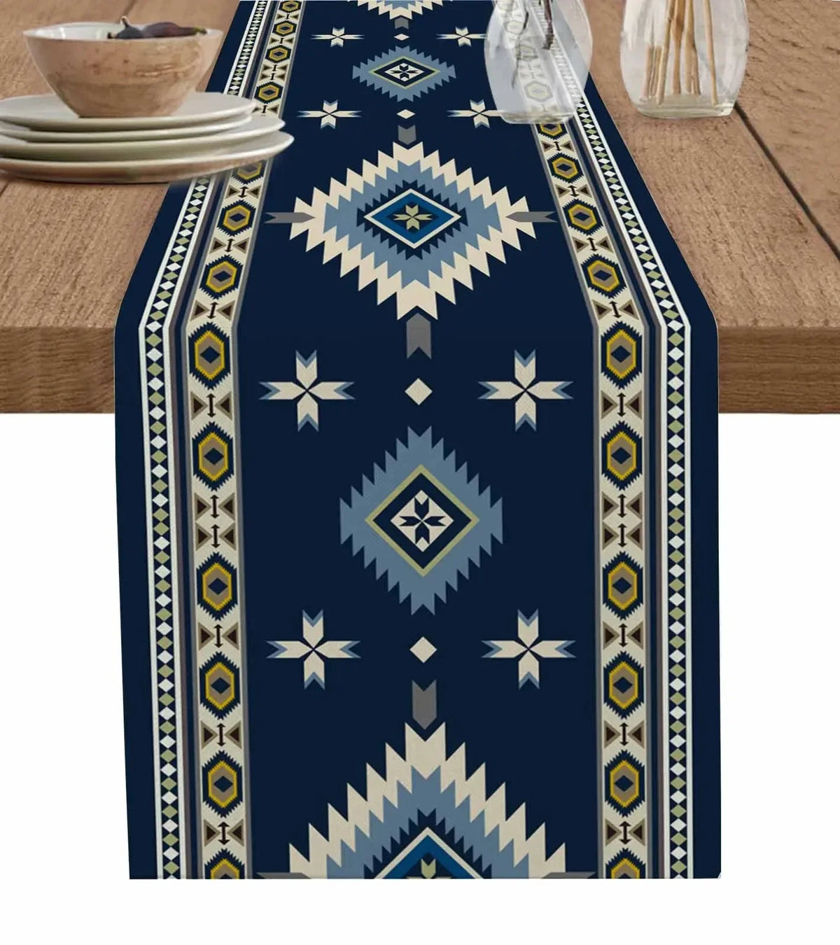 A dark blue linen table runner featuring an Indian-inspired geometric pattern in cream, yellow, and light blue.