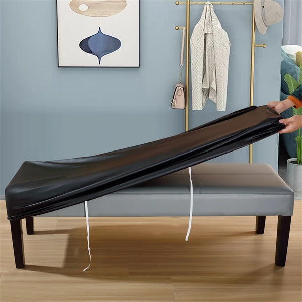 A black waterproof stretch dining bench cover is displayed on a wooden bench in a modern room.