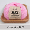Pink organic cotton yarn skein with a label showing 100% COTON ORGANIQUE and washing instructions