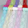 A collection of decorative lace ribbon rolls in various shades of pink, purple, green, and blue.