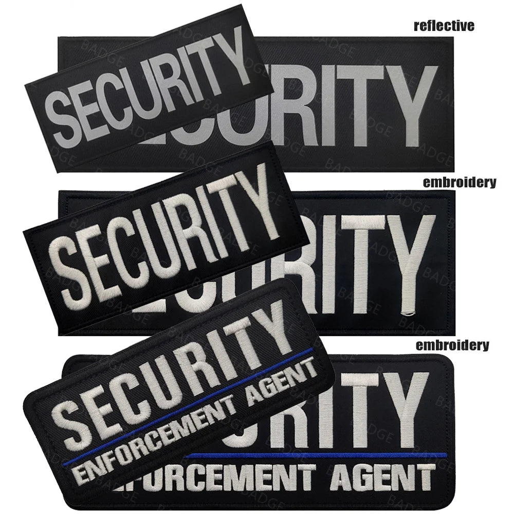 Several black embroidered security patches with silver and white text and blue accents for enforcement agents