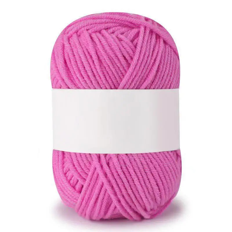 A ball of bright pink soft milk cotton knitting yarn