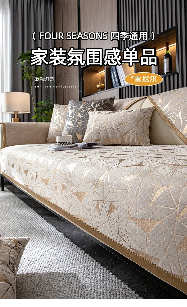 A close-up of a beige luxury chenille sofa cover featuring a geometric pattern in gold and cream tones.