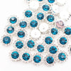 Silver and blue crystal rhinestone sew-on buttons arranged in a sunflower pattern