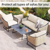 Outdoor wicker sofa set with light beige cushions and a glass table in a garden setting