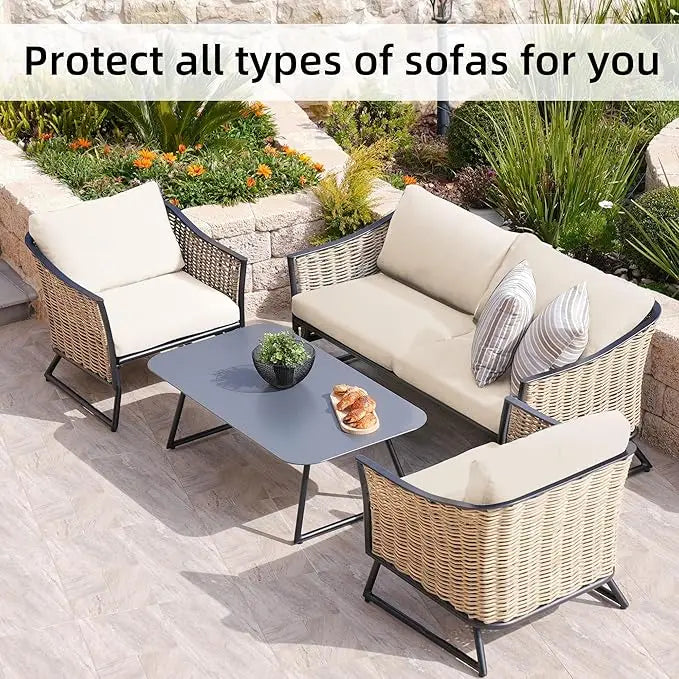 Outdoor wicker sofa set with light beige cushions and a glass table in a garden setting