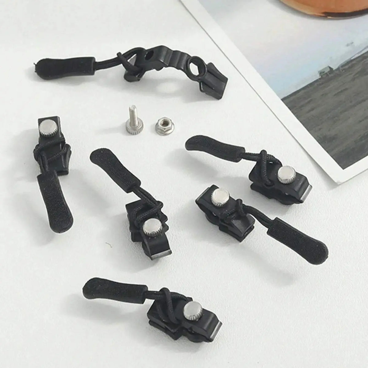 A collection of black detachable zipper repair kits for clothing, bags, and luggage.