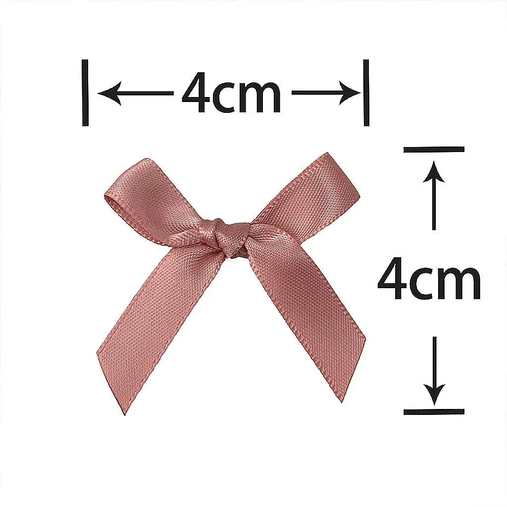 A pink satin ribbon bow shown with dimension lines indicating a 4cm size.
