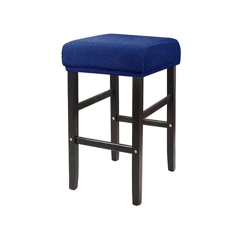 A navy blue jacquard elastic bar stool slipcover with a dark wood frame.