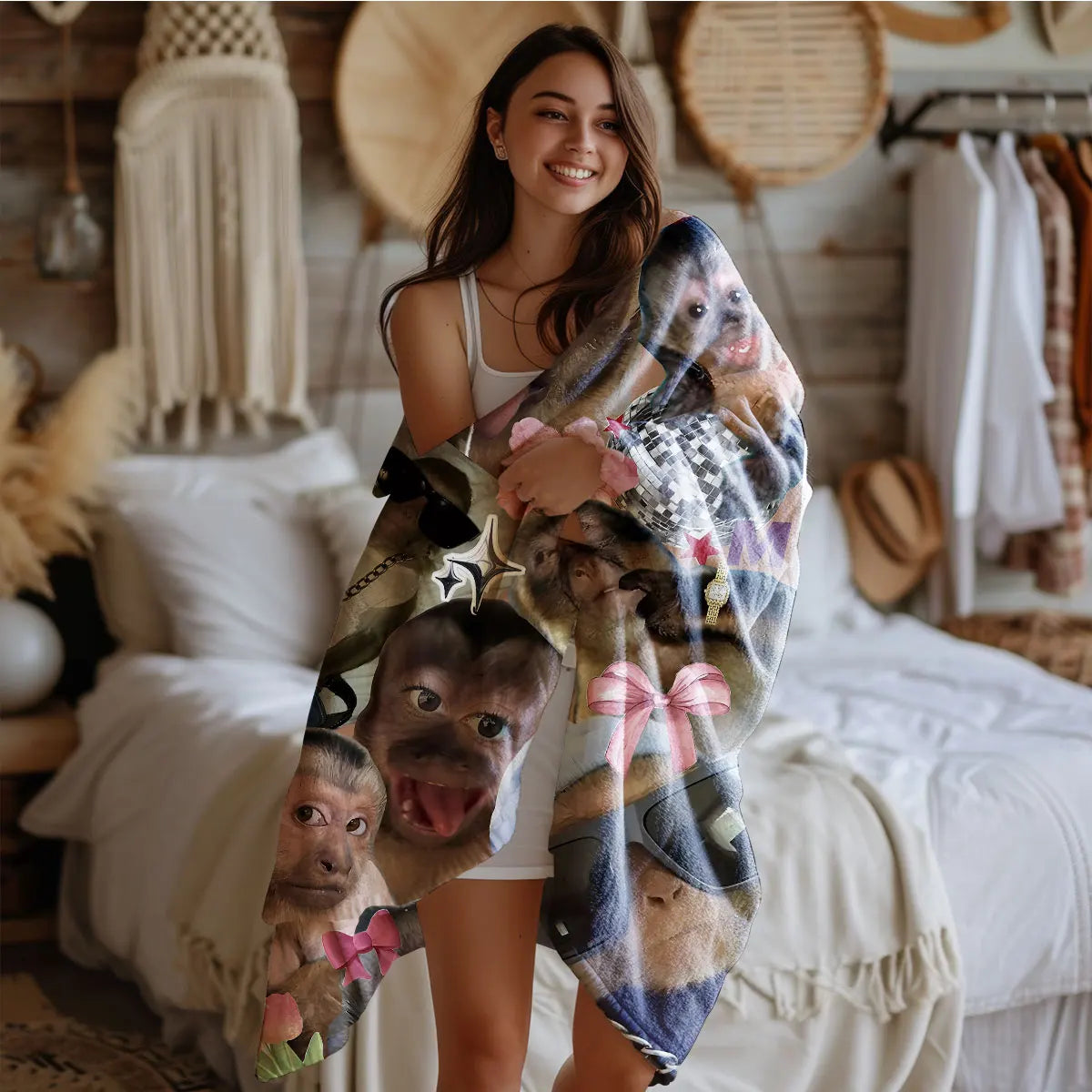 A woman is holding a funny monkey print flannel blanket in a cozy bedroom setting.