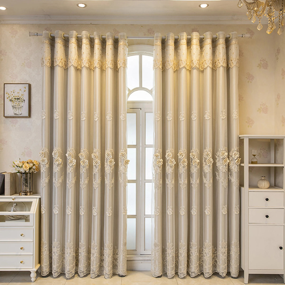 Cream and gold dual-layer blackout curtains with eyelet tops hanging in a light-colored room.