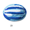 A round object covered in thick hand-knitted yarn featuring horizontal stripes of blue and white.