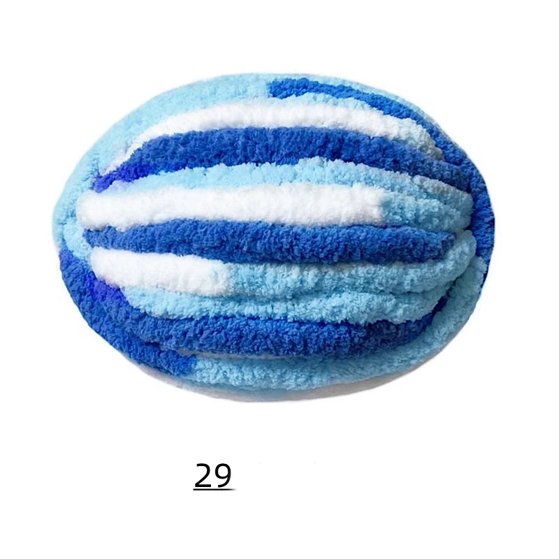 A round object covered in thick hand-knitted yarn featuring horizontal stripes of blue and white.