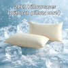 Two white pillowcases without a pillow core resting on ice cubes and snow.