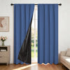 Two panels of royal blue blackout curtains with a black liner hanging in a window frame.