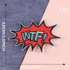 An embroidered patch with the text WTF in teal thread on a red background is shown against a blue fabric.
