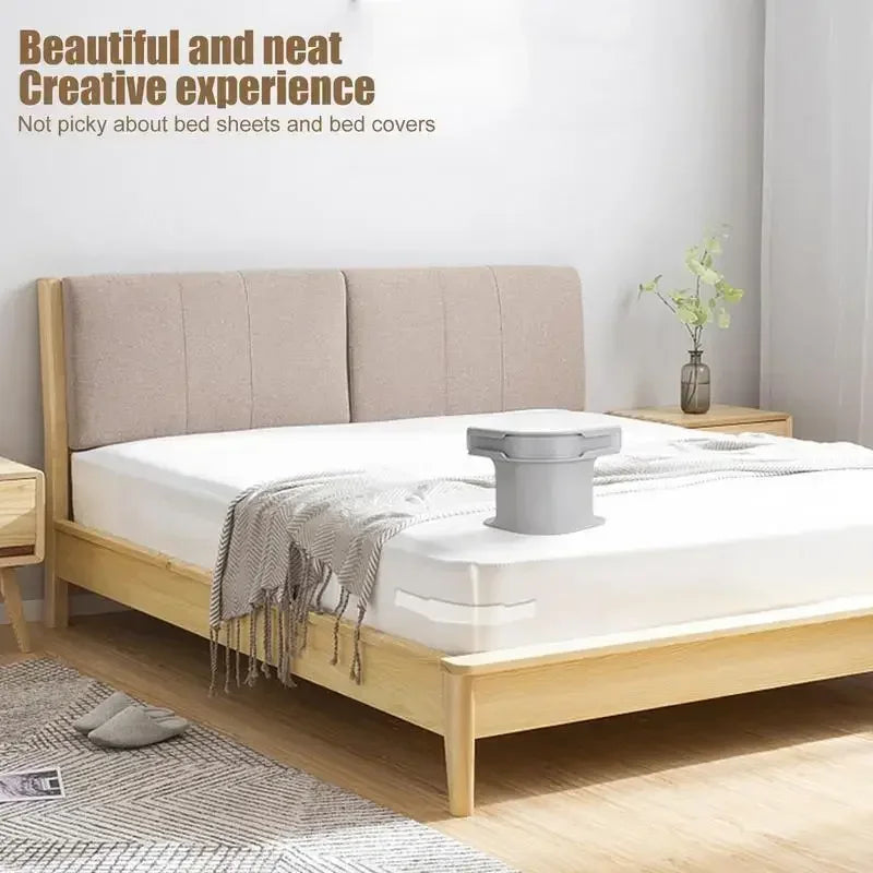 A light wood bed frame with white bedding and a gray sheet corner tightener clip on the mattress.
