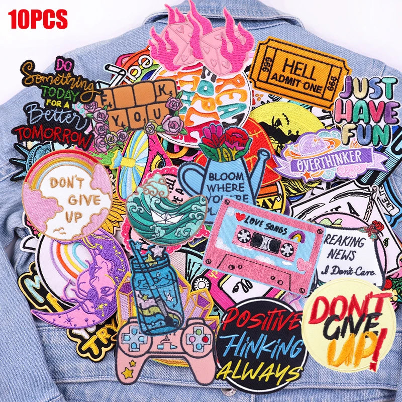 A collection of 10 embroidered letter slogan patches on a denim jacket.