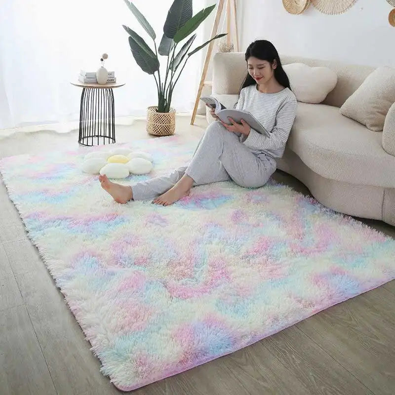 A fluffy pastel pink and blue rug is placed on a light wood floor in a modern living room setting.
