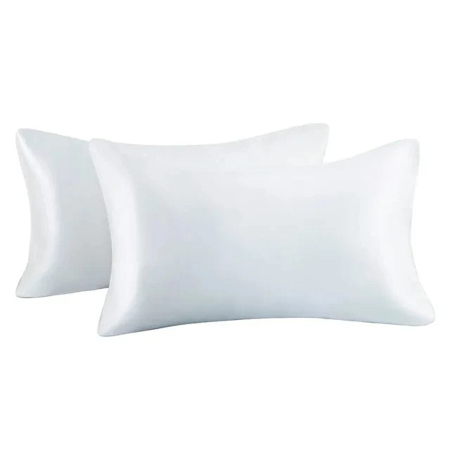 A pair of white silky satin pillow covers for a queen size pillow.