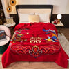 A vibrant red blanket with intricate rose and peony floral patterns is displayed on a bed.