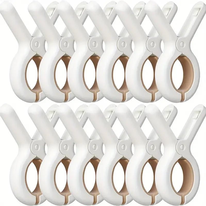 A row of white heavy-duty plastic clothespins with rust-resistant springs.