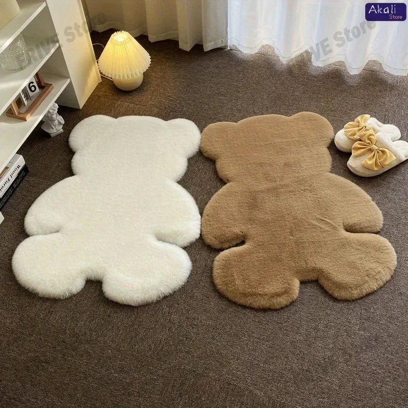 Two plush bear-shaped non-slip area rugs in white and brown resting on a gray carpet.