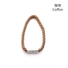 A braided cord magnetic curtain tieback clip in a natural tan color.