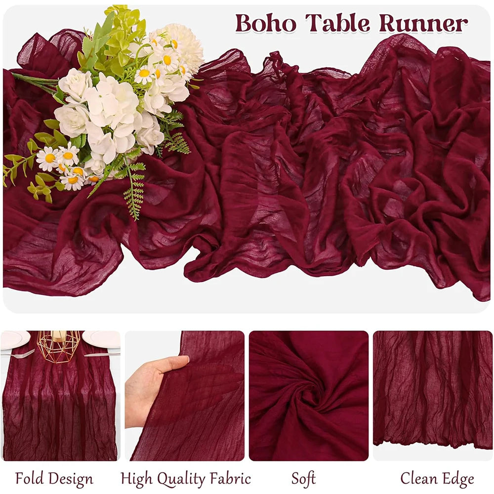 A deep burgundy sheer fabric table runner with floral accents, showcasing soft folds and a clean edge.