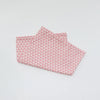 A pink patterned soft cotton baby pillow cover with a geometric triangle design.