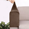 A dark brown velvet sofa armrest cover is being held by a hand, shown next to a light gray sofa.