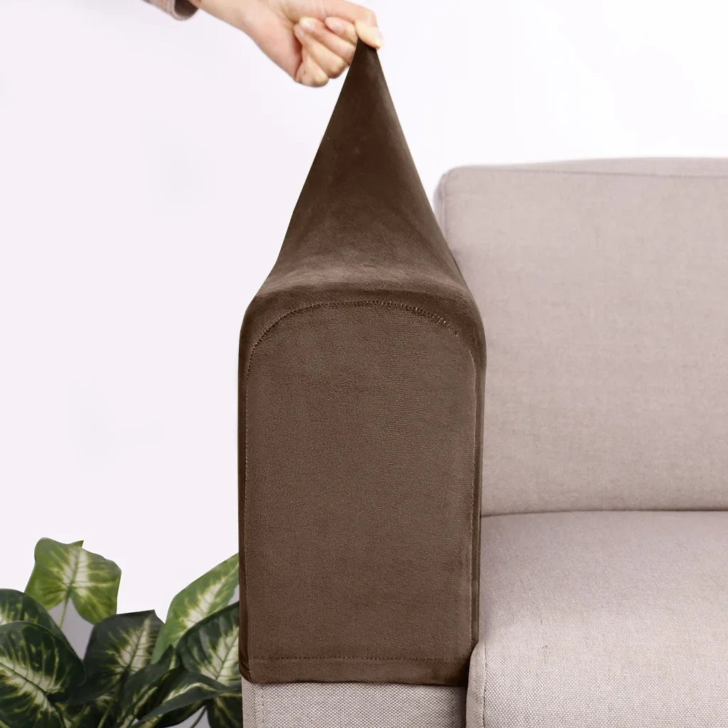A dark brown velvet sofa armrest cover is being held by a hand, shown next to a light gray sofa.