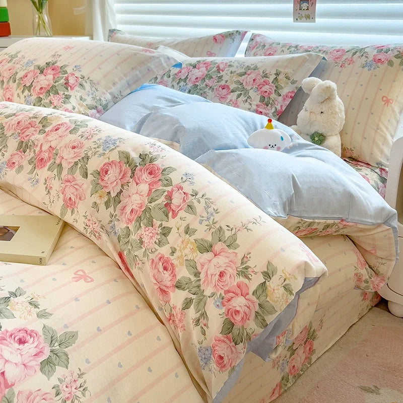A bed dressed with a lavender print duvet cover set featuring pink and green floral patterns.