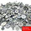 A pile of assorted gray resin sewing buttons for crafting and DIY projects.