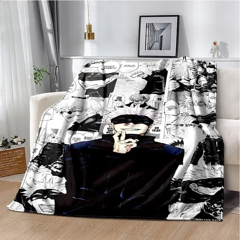 A black and white graphic throw blanket featuring Jujutsu Kaisen anime characters and scenes.