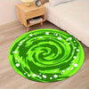 Vibrant green swirl round area rug placed on a wooden floor next to a bed.