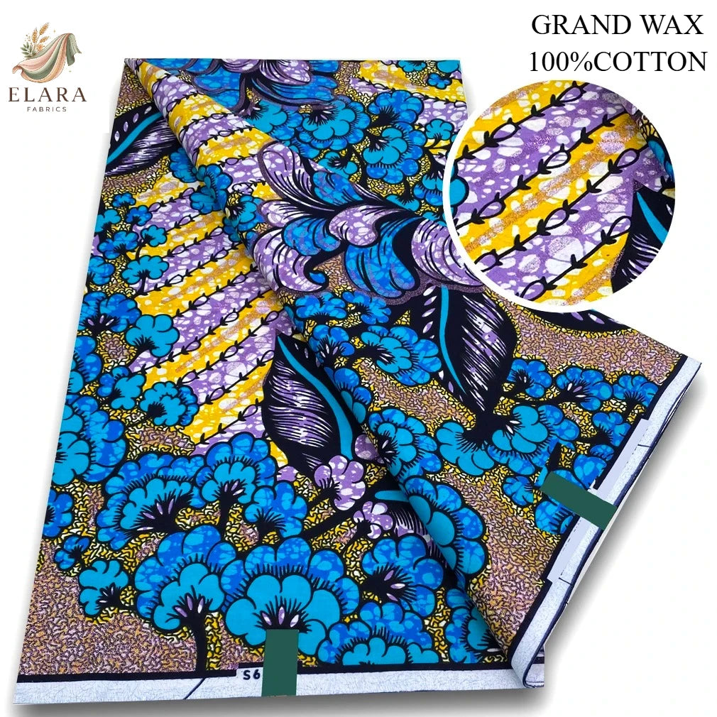 A bolt of blue and purple African wax print fabric featuring floral and abstract patterns.