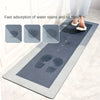 A gray non-slip floor mat demonstrating fast absorption of water and oil stains on a tile floor.