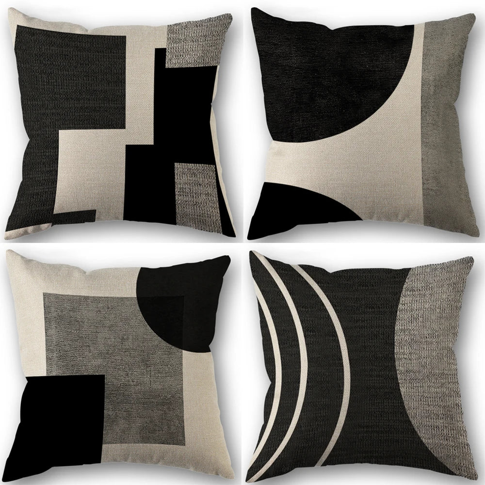 A set of abstract geometric throw pillow covers in black, white, and beige tones.