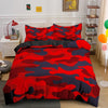 A red and blue camouflage duvet cover set displayed on a bed with white bedside tables.