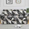 A modern sofa covered in a black and white marble geometric pattern.