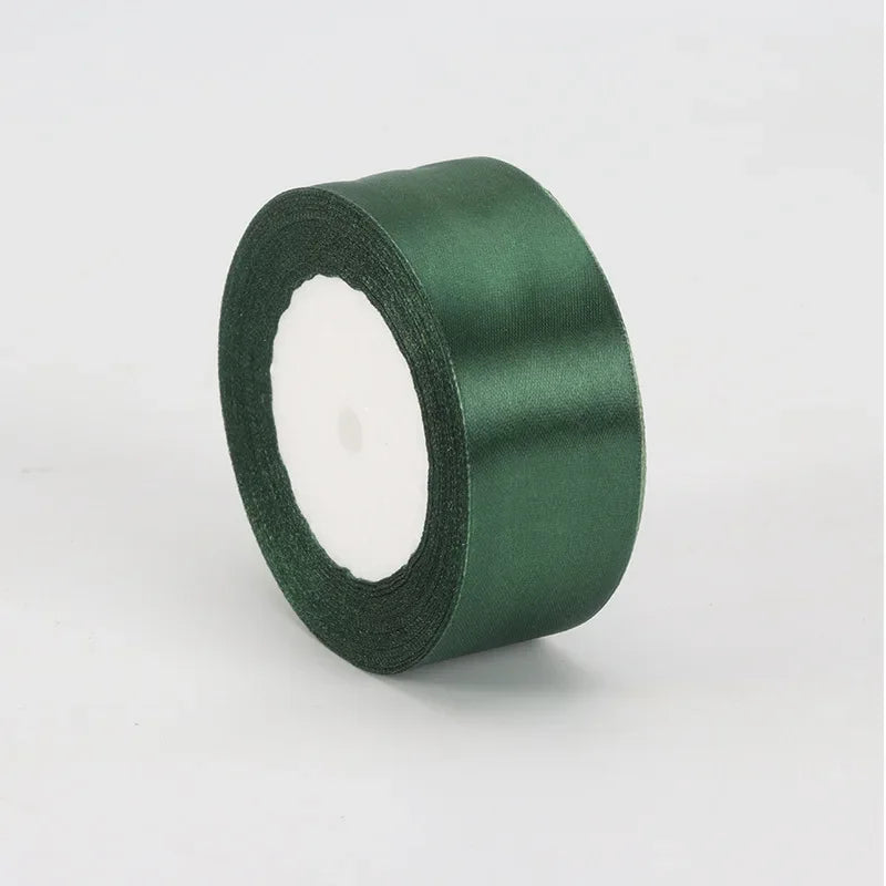 A roll of dark green satin ribbon measuring 4cm for crafts and gift wrapping.