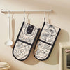 Two floral heat-resistant oven mitts are hanging on a kitchen rack against a beige wall.