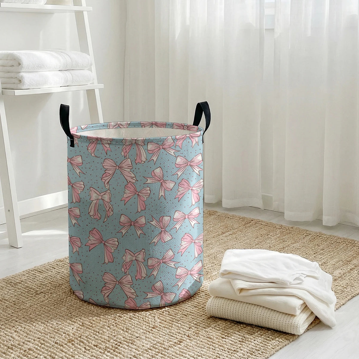 A light blue and pink patterned foldable canvas laundry basket sitting on a woven mat next to sheer white curtains.