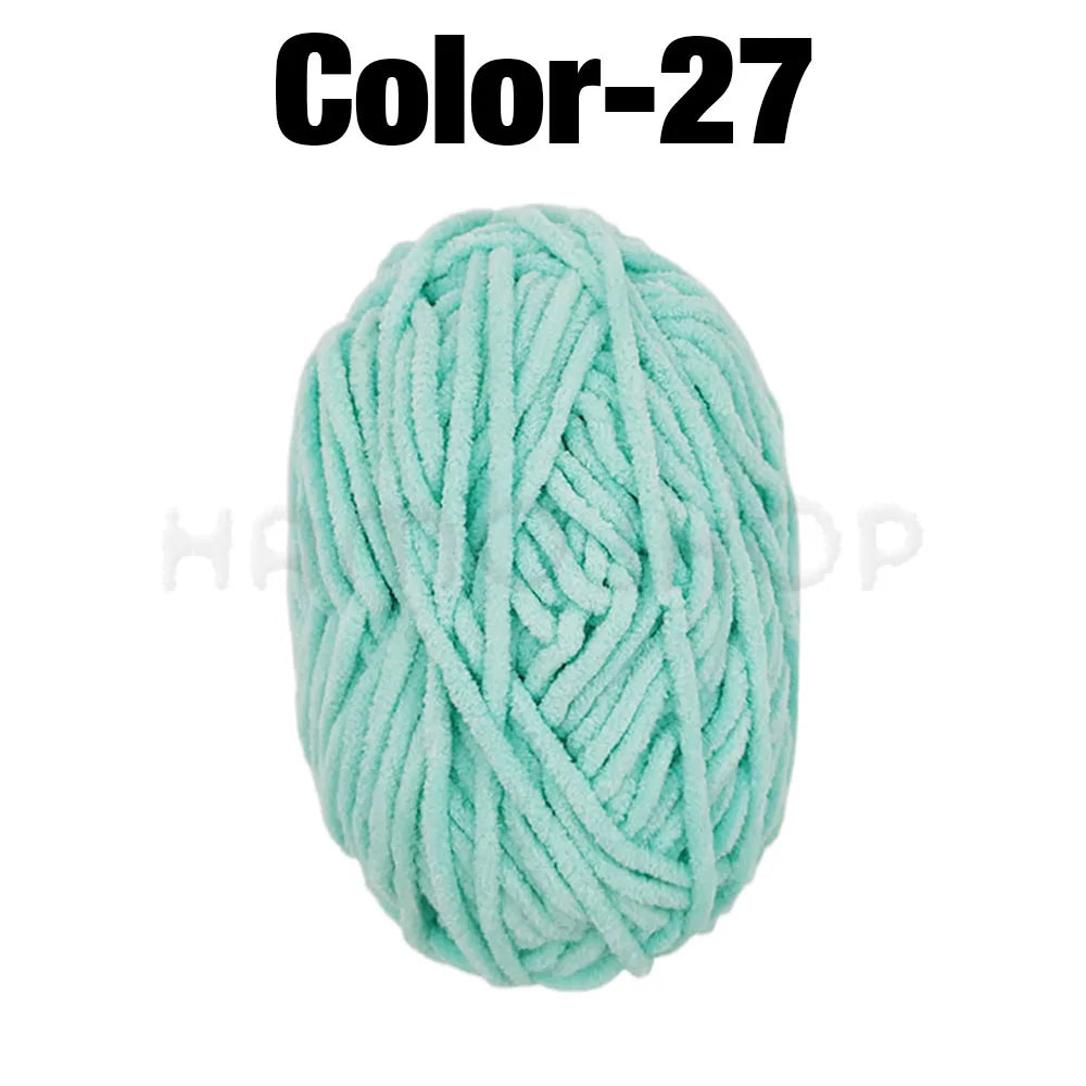 A ball of light mint green chenille yarn labeled Color-27 for crafting.